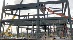 Workers on lift installing Deep-Dek® Composite on steel girders