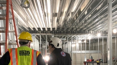 Interior construction 2 workers inspecting composite floor deck