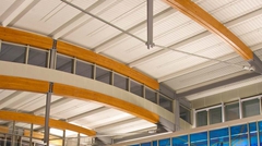 Close-up of arched wood beam structure with Curve-Dek®